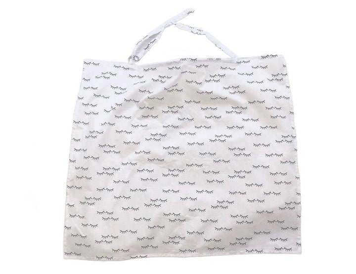 Жінка використовує стильну та зручну накидку для годування, що забезпечує комфорт та конфіденційність під час грудного вигодовування на природі.